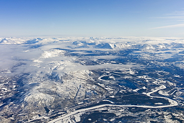 Aerial view of arctic landscape, frozen river and the Lyngen Alps from aircraft approaching Tromso in the Arctic Circle in Northern Norway