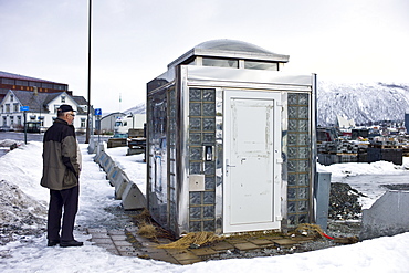 Man gazes at futuristic design Public Convenience toilet in Tromso, Norway