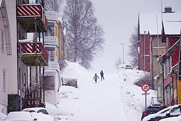 Children running in the snow in Tromso within the Arctic Circle in Northern Norway