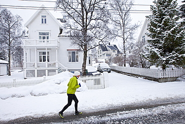 Local woman jogging in Jonas Lies Gate, the elegant  residential area of Tromso within the Arctic Circle in Northern Norway