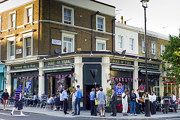 Customers enjoying warm weather at The Duke of York traditional London pub in St John's Wood, London