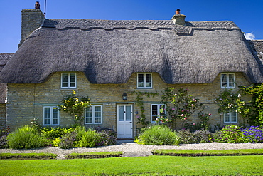 Quaint traditional thatched cottage in Minster Lovell in The Cotswolds, Oxfordshire, UK