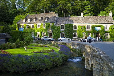 Swan Hotel and River Coln at Bibury in The Cotswolds UK. L to R: Audi A8, Mercedes C Class (2 silver cars), BMW 7 Series