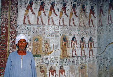 Egyptian man standing guard in King Seti's tomb in the Valley of the Kings, Luxor, Egypt