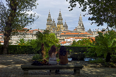 Young tourists in Alameda Park view Roman Catholic cathedral, Catedral de Santiago de Compostela, cityscape, Galicia, Spain