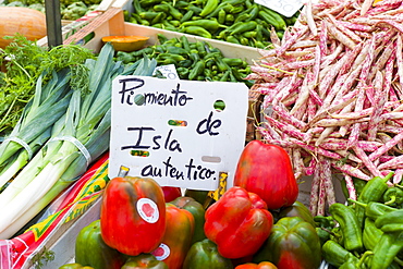 Pimentos, leeks, demi-sec beans of Cantabria on sale in food market in Santander, Northern Spain