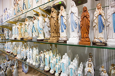 Religious statues on sale in gift shop in the pilgrimage town of Lourdes in the Pyrenees, France