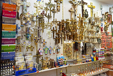 Religious icons on sale in gift shop in the pilgrimage town of Lourdes in the Pyrenees, France