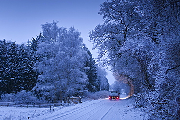 Traditional snow scene with Toyota pick-up truck in The Cotswolds, Swinbrook, Oxfordshire, United Kingdom