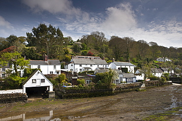 White painted houses in Helston village overlooking the Helford Estuary with the tide out, Cornwall, England, UK