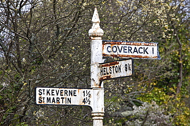 Quaint old rusty signpost to tourist attractions Coverack, Helston, St Keverne and St Martin in Cornwall, England, UK