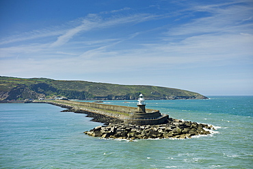 Fishguard Harbour wall and lighthouse with sea defences, Pembrokeshire, Wales, UK