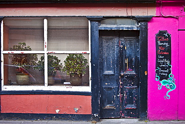 Faded elegance of a salon offering tattoo, piercing, body jewellery in Youghal, County Cork, Southern Ireland