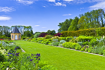 Garden at Ballymaloe Cookery School with Gothic style summer house and perennial borders, County Cork, Ireland