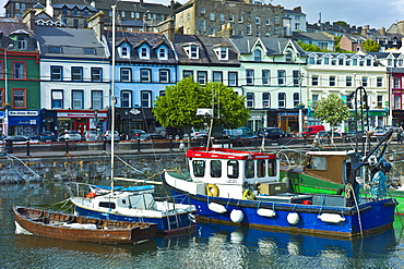 Popular as a tourist destination Cobh harbour with brightly coloured fishing boats in County Cork, Ireland