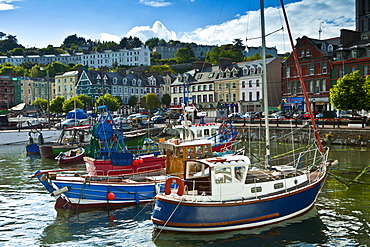 Popular as a tourist destination Cobh harbour with brightly coloured fishing boats in County Cork, Ireland