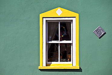 Aquamarine colour wall and yellow window border in Kinsale, County Cork, Ireland