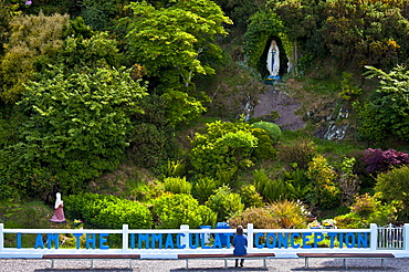 Pilgrim at Grotto of the Virgin Mary and The Immaculate Conception at Ballinspittle near Kinsale, County Cork, Ireland