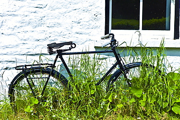 Old bicycle outside house near Ballinspittle, County Cork, Ireland