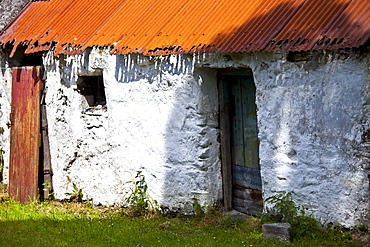 Whitewashed barn with rusty corrugated iron roof in County Cork, Ireland