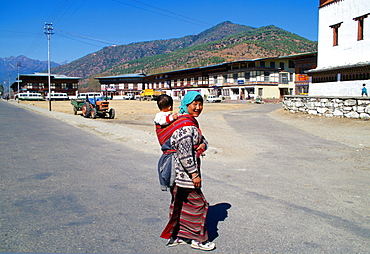 Woman with child in sling, Paro, Bhutan