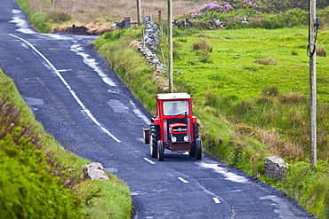 Small farm tractor in the lanes in County Clare, West of Ireland