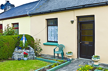 Grotto and statue of the Blessed Virgin Mary in Catholic tradition in front of house in Kilkee, County Clare, West of Ireland