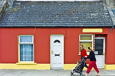 Irish women with child in stroller pushchair in street in Kilkee, County Clare, West of Ireland