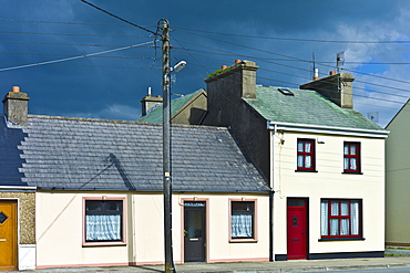 Street scene pastel painted terraced homes in Kilkee, County Clare, West of Ireland