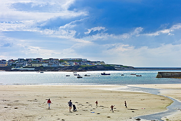 Women with children play on the strand in Kilkee bay popular beach resort, County Clare, West Coast of Ireland