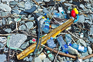 Plastic detritis and debris litter the rocks on a beach, County Clare, West Coast of Ireland