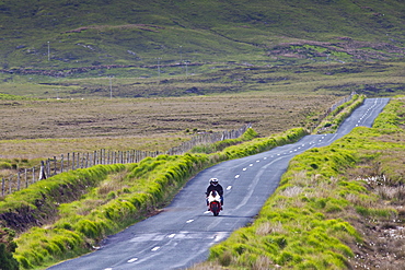 Motorcyclist on Kylemore Pass in Connemara National Park, County Galway, Ireland