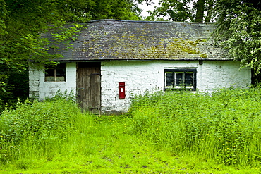 Quaint cottage with wall mounted postbox in Anchor, Shropshire, United Kingdom