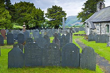 Church of St Michael and churchyard with Welsh slate gravestones at Llanfihangel-Y-Pennant in Snowdonia, Wales