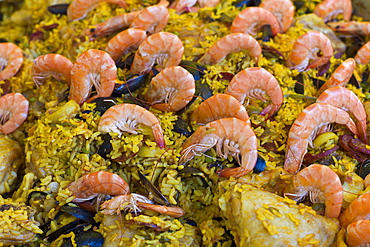 Fresh-cooked seafood and chicken Paella on sale at food market at La Reole in Bordeaux region of France