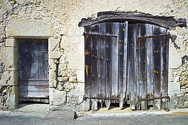 Traditional weathered French doorway in quaint town of Castelmoron d'Albret in Bordeaux region, Gironde, France