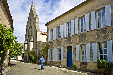 Man strolls in quaint town of Castelmoron d'Albret in Bordeaux region, Gironde, France