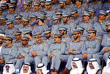 Military chiefs in uniform watching parade of armed forces in Abu Dhabi, United Arab Emirates