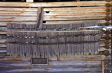 Klosters - Amongst the Silvretta group of the Swiss Alps.Tools for summer hay harvest stored on the side of traditional wooden barn.