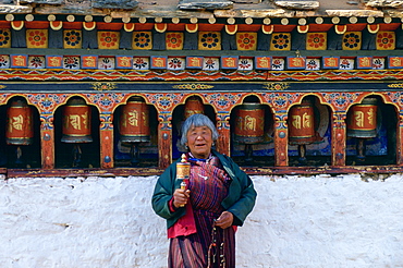 Woman holding prayer wheel at Kyichu Temple, Paro, Bhutan