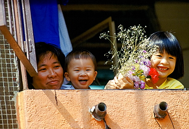 Mother with her children at home in Hong Kong China in the 1980s