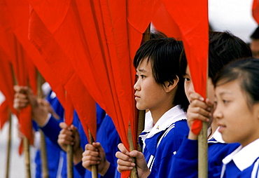 Young Chinese students with red flags at cultural display in Lintong,  China