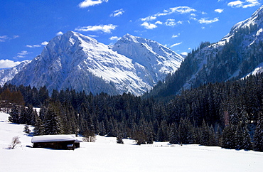 Snow covered barns in the meadows below the Alps at Klosters - Amongst the Silvretta group of the Swiss Alps. Road to Silvretta.Mountain at right is P.Linard 3411 metres high