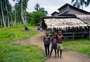 Small boys laughing together in a village settlement, Solomon Isles, South Pacific