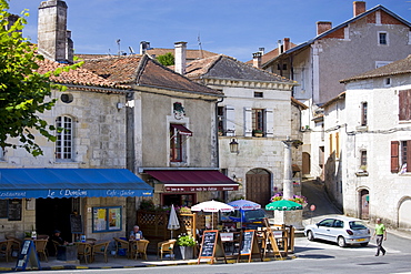 Tourists in quaint town of Bourdeilles popular tourist destination near Brantome in Northern Dordogne, France