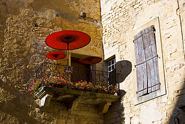 Sun parasols on balcony veranda at gallery in popular picturesque tourist destination of Sarlat in the Dordogne, France