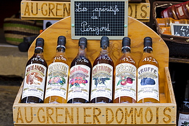 Les Aperitifs de Perigord, truffle, peach, red fruits flavor, on sale in market at Domme in the Dordogne, France