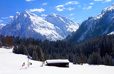 Snow covered barns in the meadows below the Alps at Klosters - Amongst the Silvretta group of the Swiss Alps. Road to Silvretta.Mountain at right is P.Linard 3411 metres high