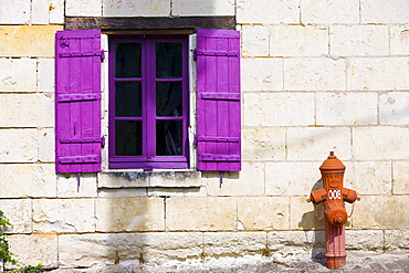 Brightly painted window and traditional water hydrant at Parnay near Saumur in the Loire Valley, France