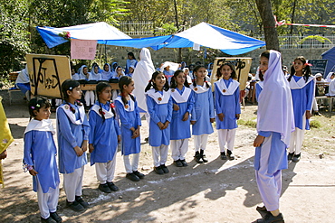 Schoolchildren have lessons outdoors after earthquake in village of Pattika, Pakistan